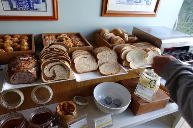 モアナサーフライダー「ベランダ」の朝食部ブッフェに並ぶたくさんの種類のパンの写真